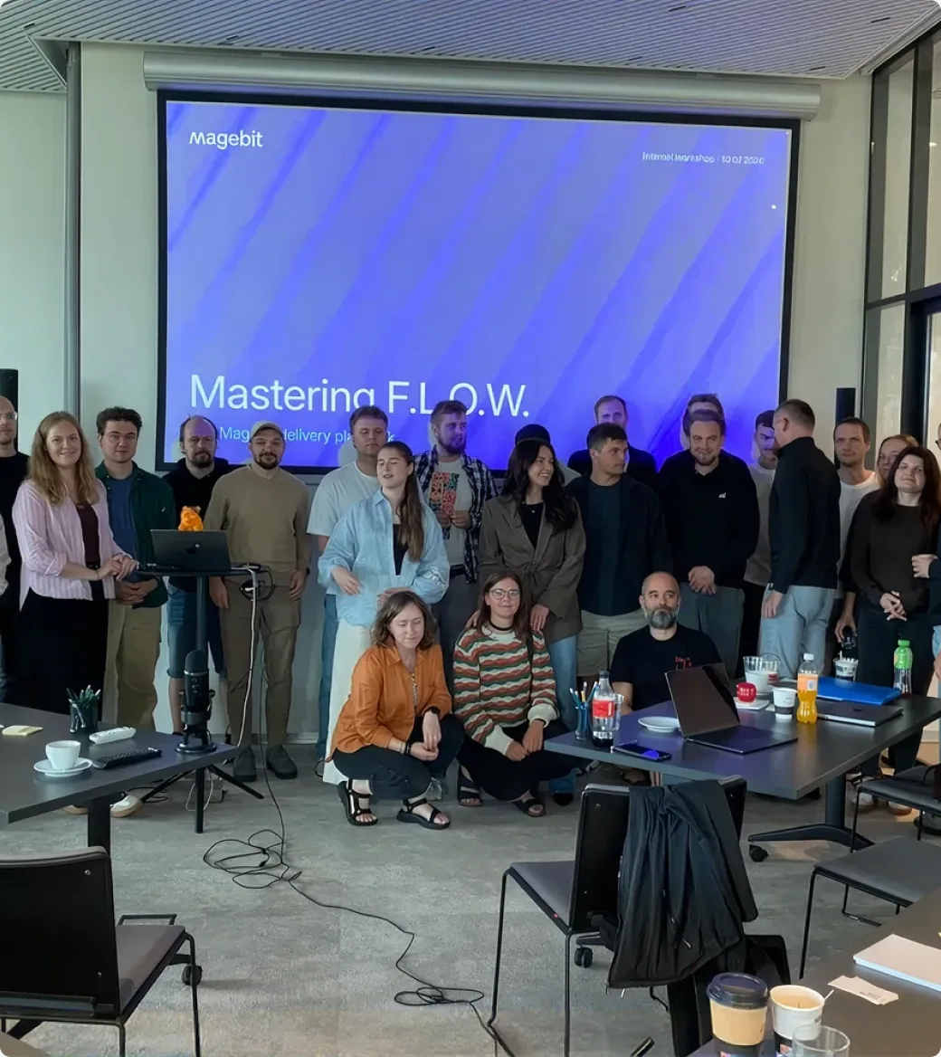 The Magebit team in front of a Mastering F.L.O.W. workshop slide.