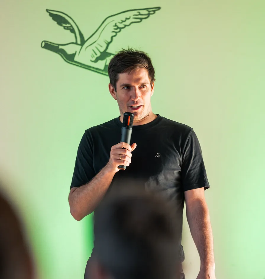 Arturs Kruze, co-founder of Magebit, speaking at an event.