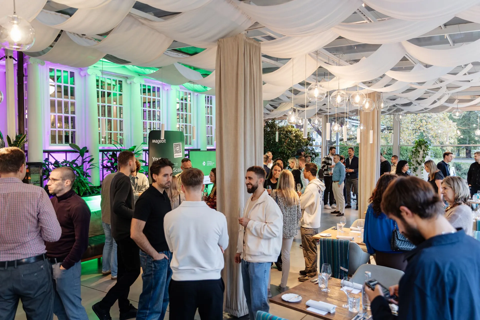 Guests mingling under the draped ceiling at Kolonāde before the Shopify in Latvia with Magebit 2026 dinner