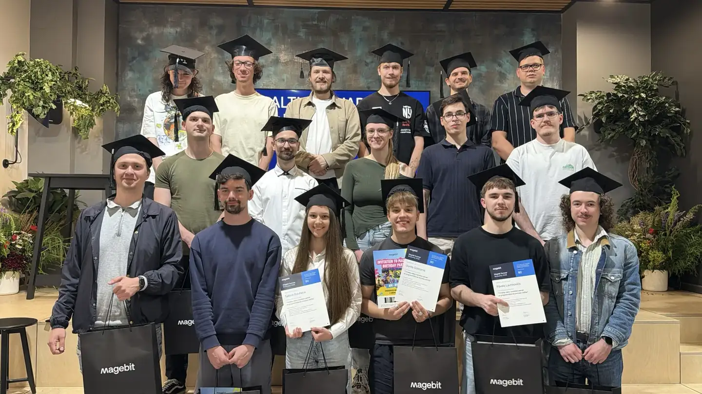 Magebit IT Bootcamp 2026 graduates in mortarboards holding certificates and Magebit bags
