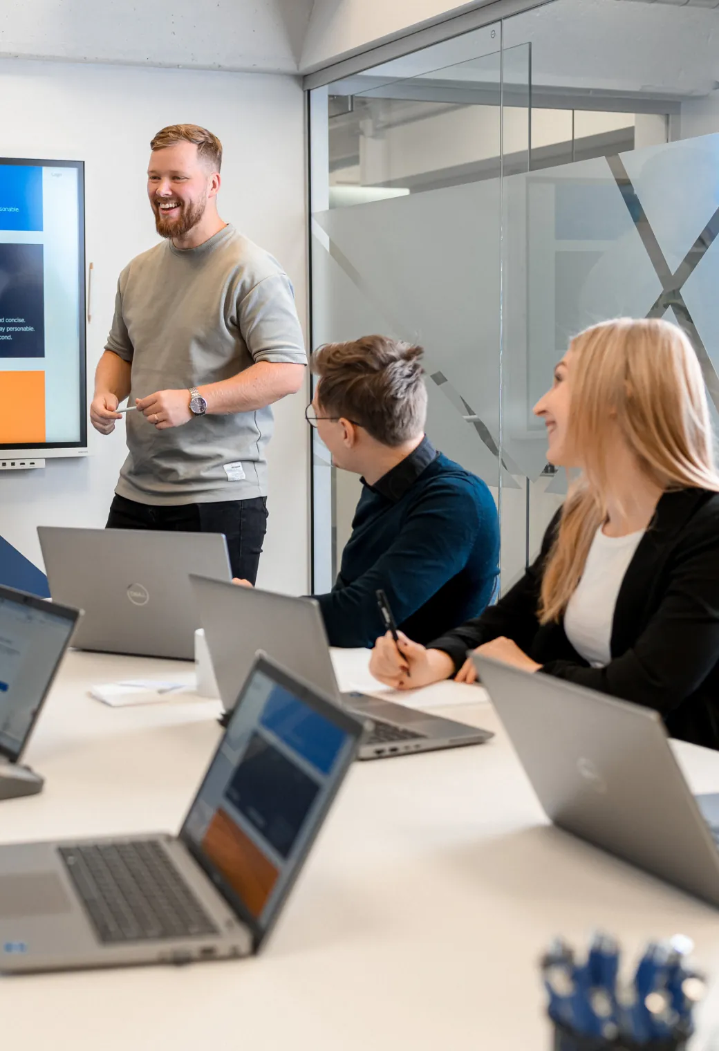Magebit team collaborating with a client in a meeting room