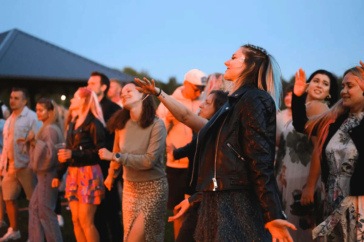 Colleagues dancing at an outdoor evening party