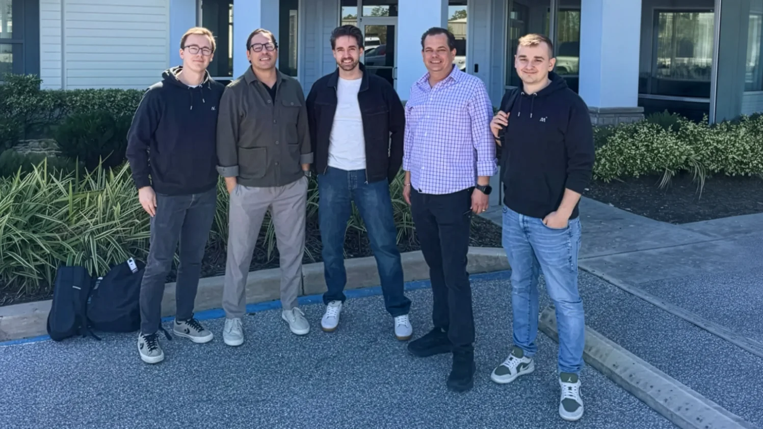 Five members of the Magebit team standing outside the Satellite Phone Store office in Florida, USA