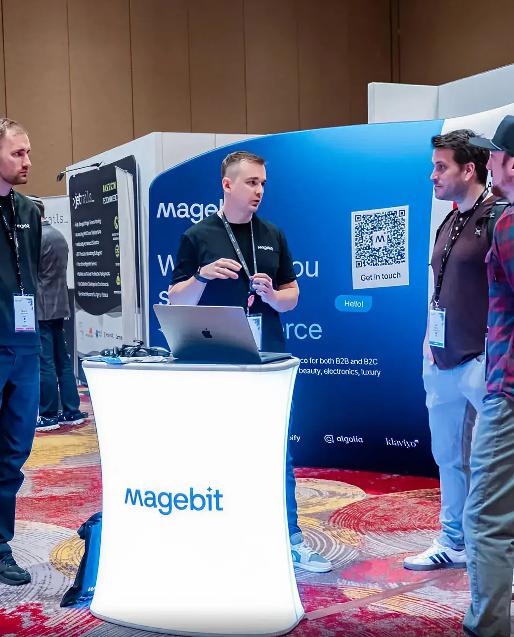 Magebit team presenting at their stand at Meet Magento