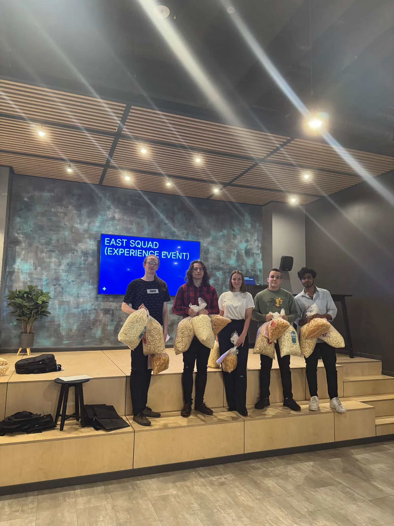 A Bootcamp squad on stage with their gift bags at the Magebit Bootcamp 2025 closing