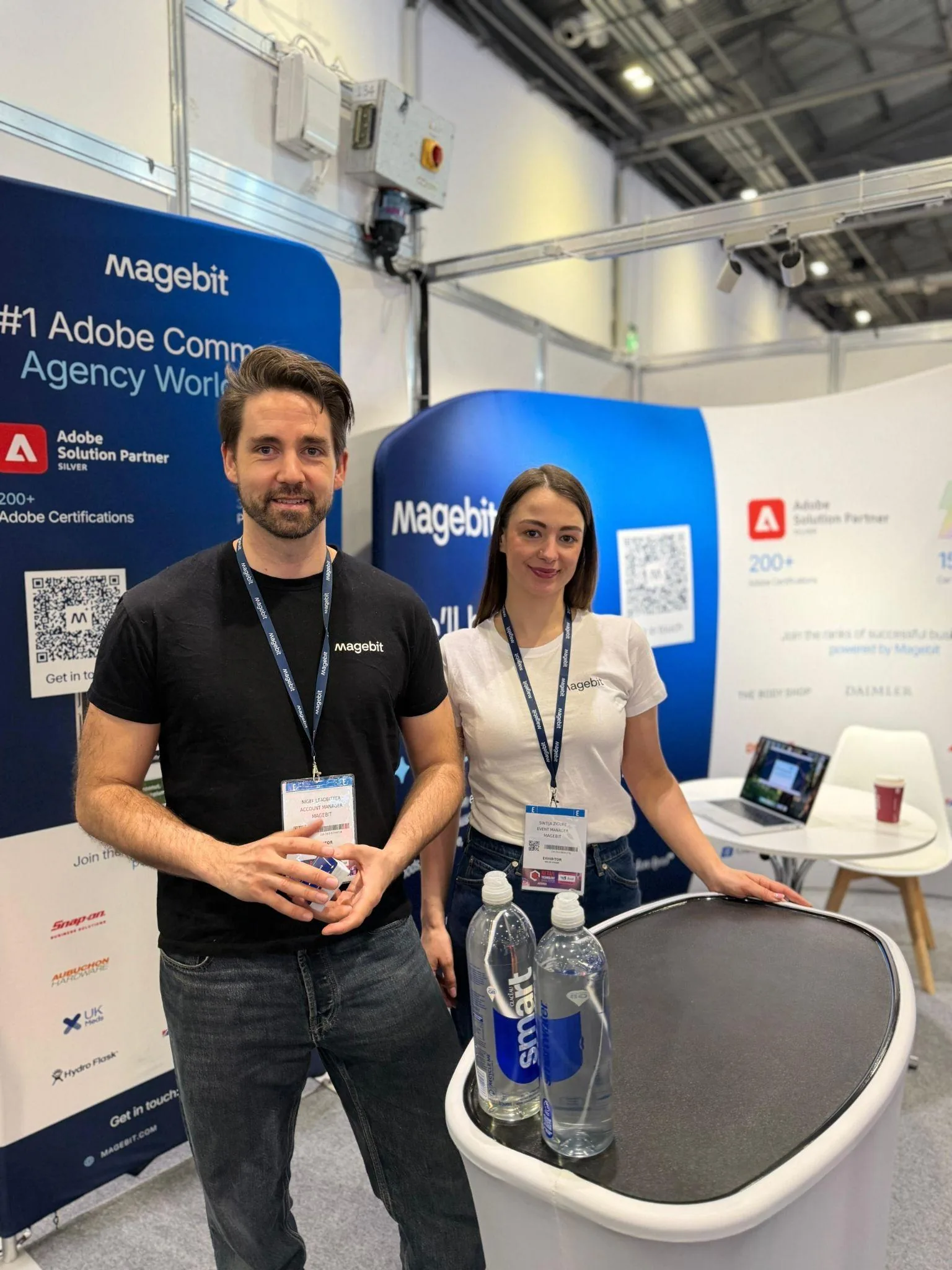 Arturs Kruze and Nigel Leadbitter in front of the Magebit booth at ExCeL London