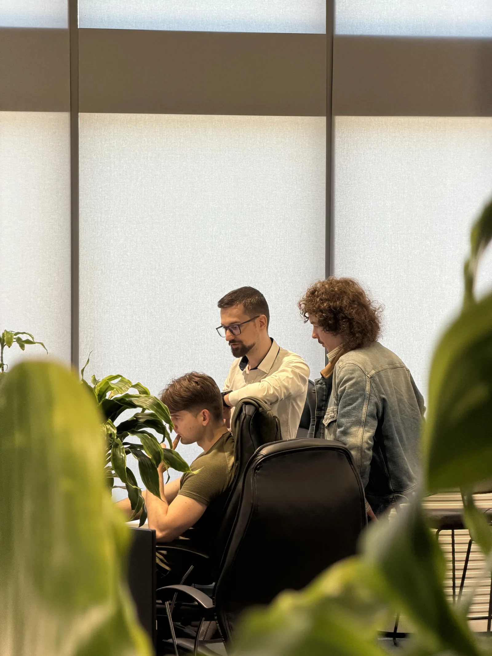 A Magebit mentor working through code with bootcamp participants at a desk