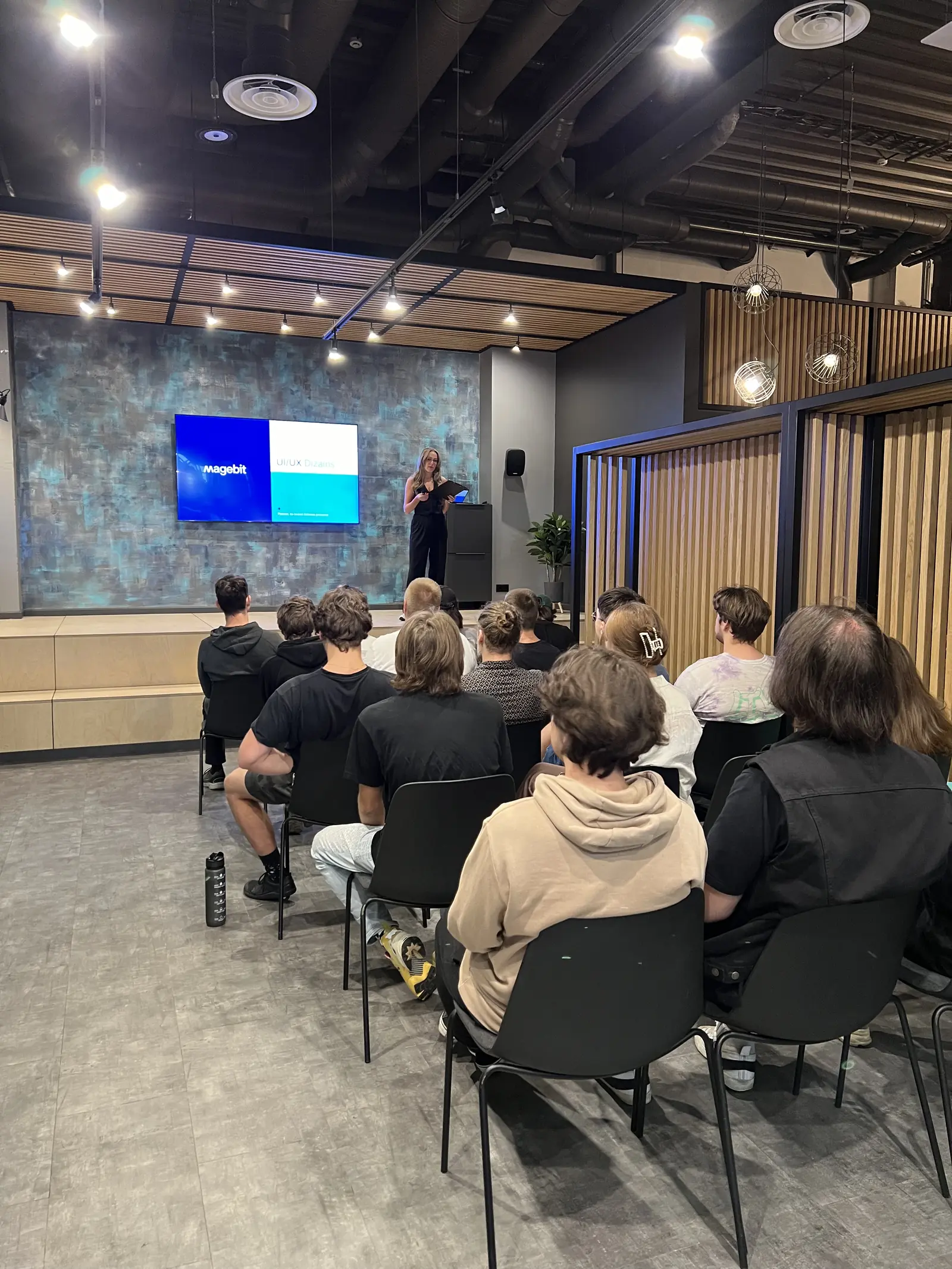Participants listening to a UI/UX design guest lecture at the Magebit IT Bootcamp 2024