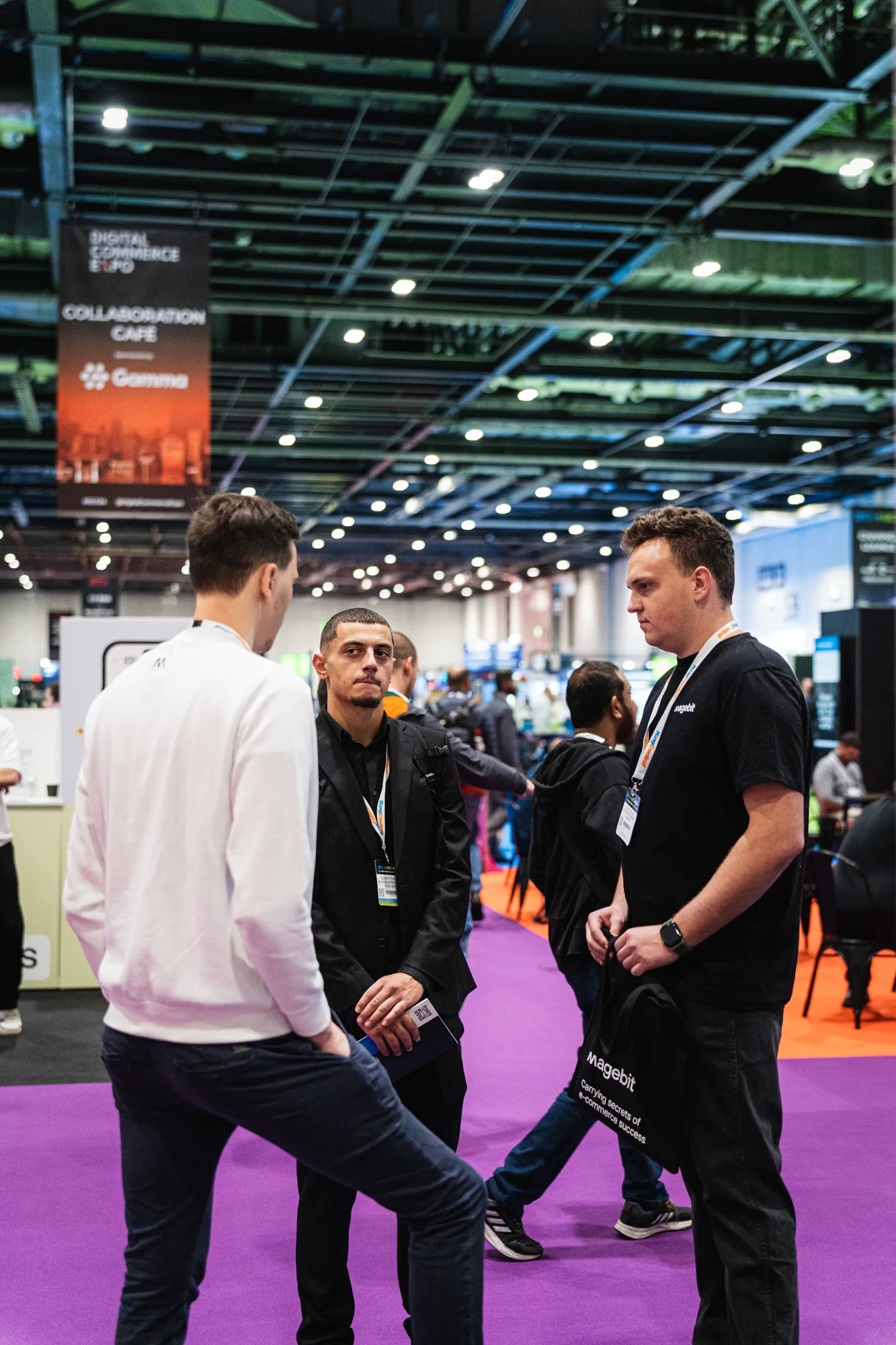 Magebit team members talking with visitors in the Digital Commerce Expo 2024 hall
