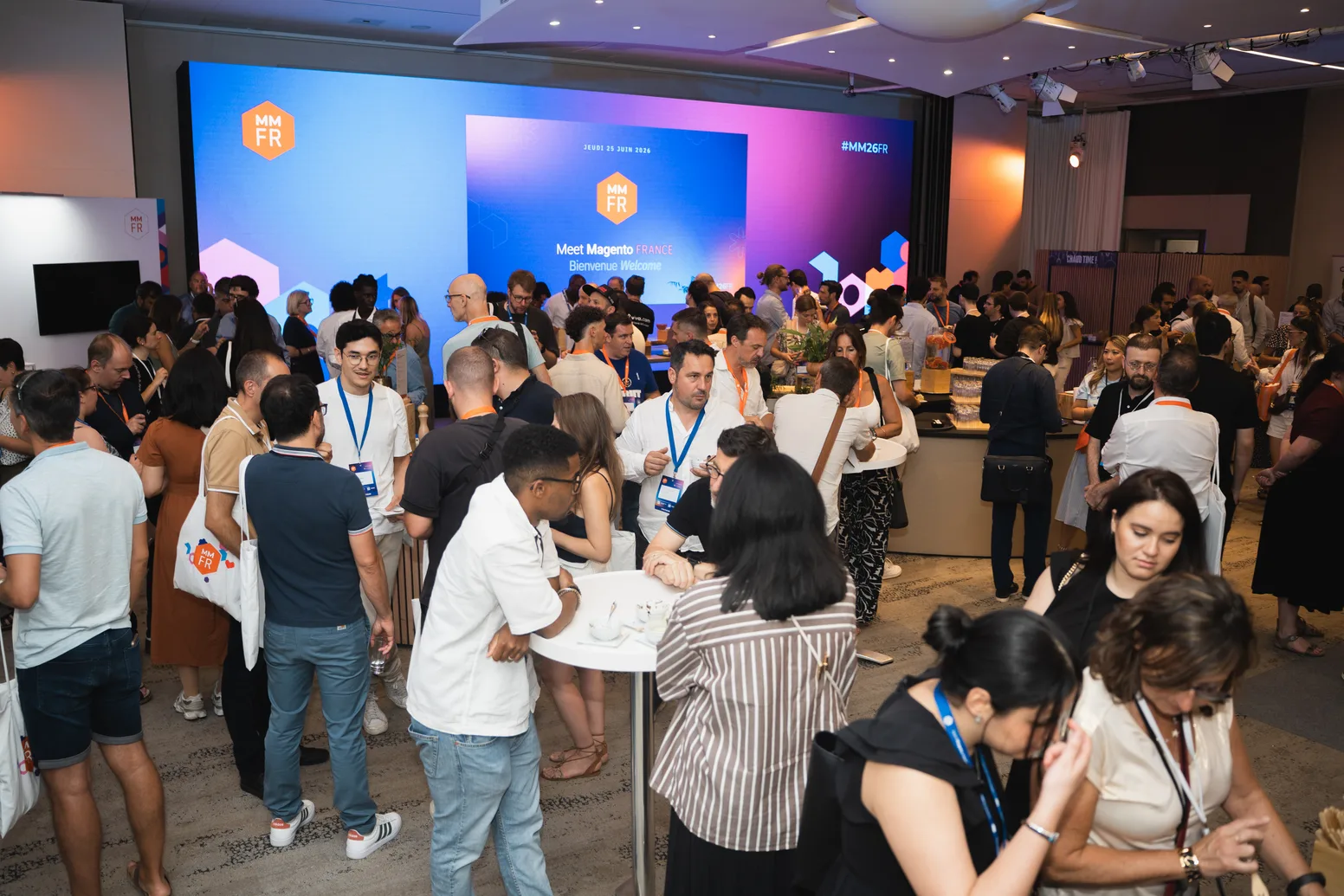Attendees networking between sessions at Meet Magento France 2026