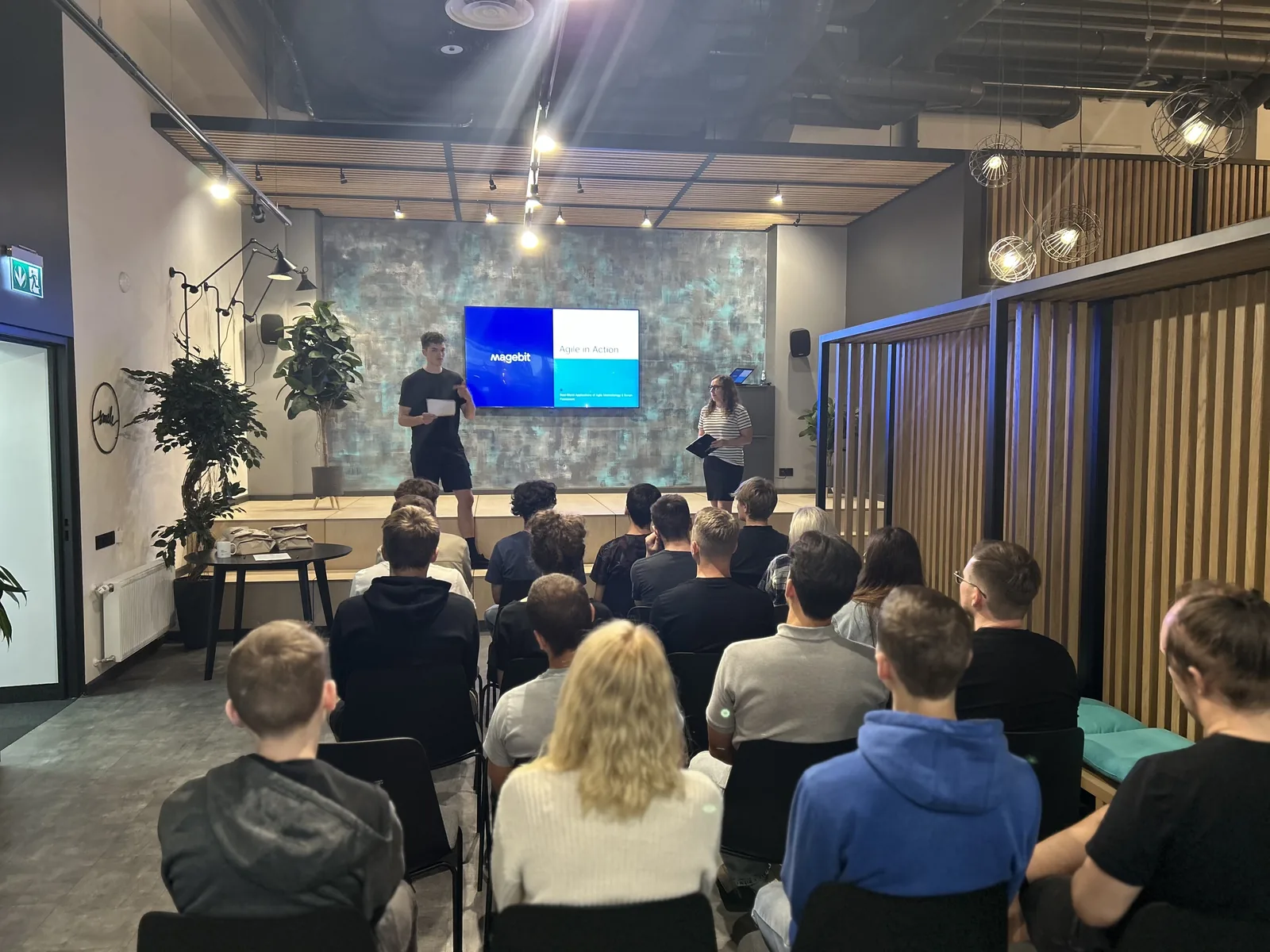 A full room of bootcamp participants listening to the agile session on the Magebit office stage