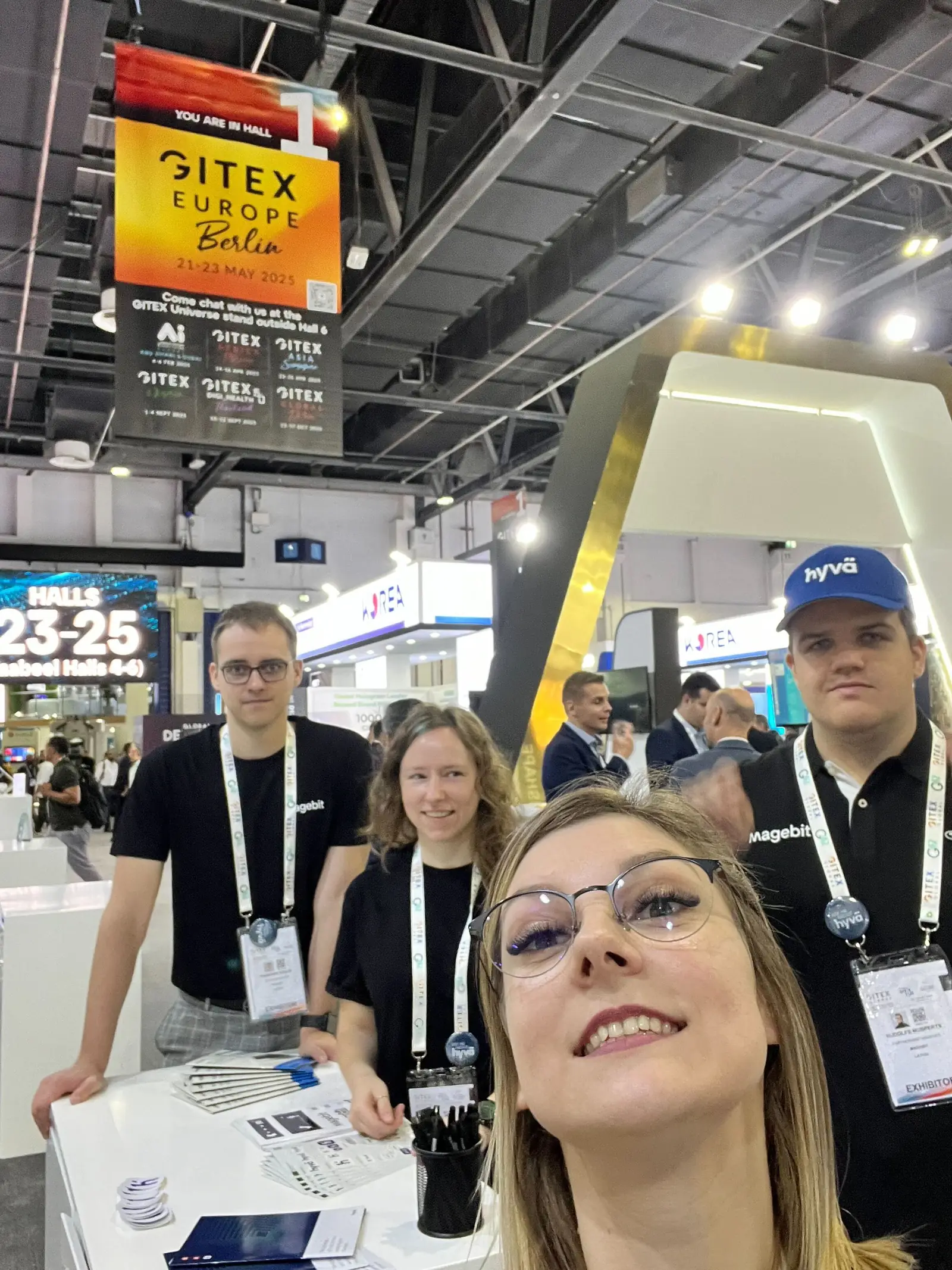 Magebit team selfie at the stand under a GITEX Hall 1 banner at GITEX Global 2024