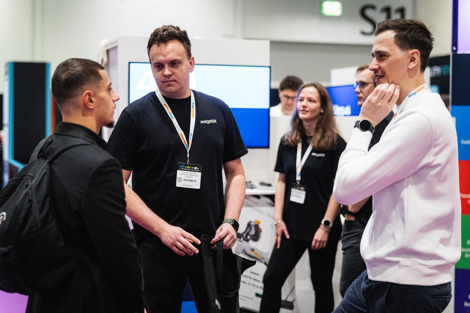 Magebit team in conversation with visitors at the Magebit stand at Digital Commerce Expo 2024