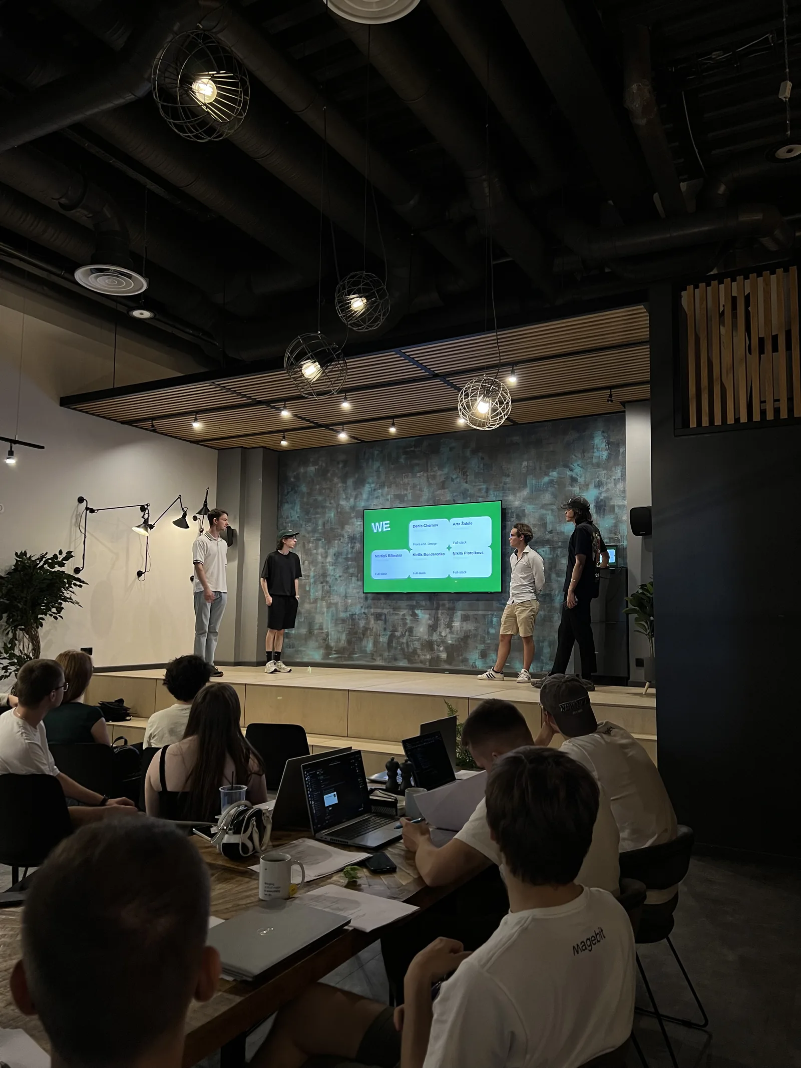 A bootcamp team introducing its members on stage before presenting its project