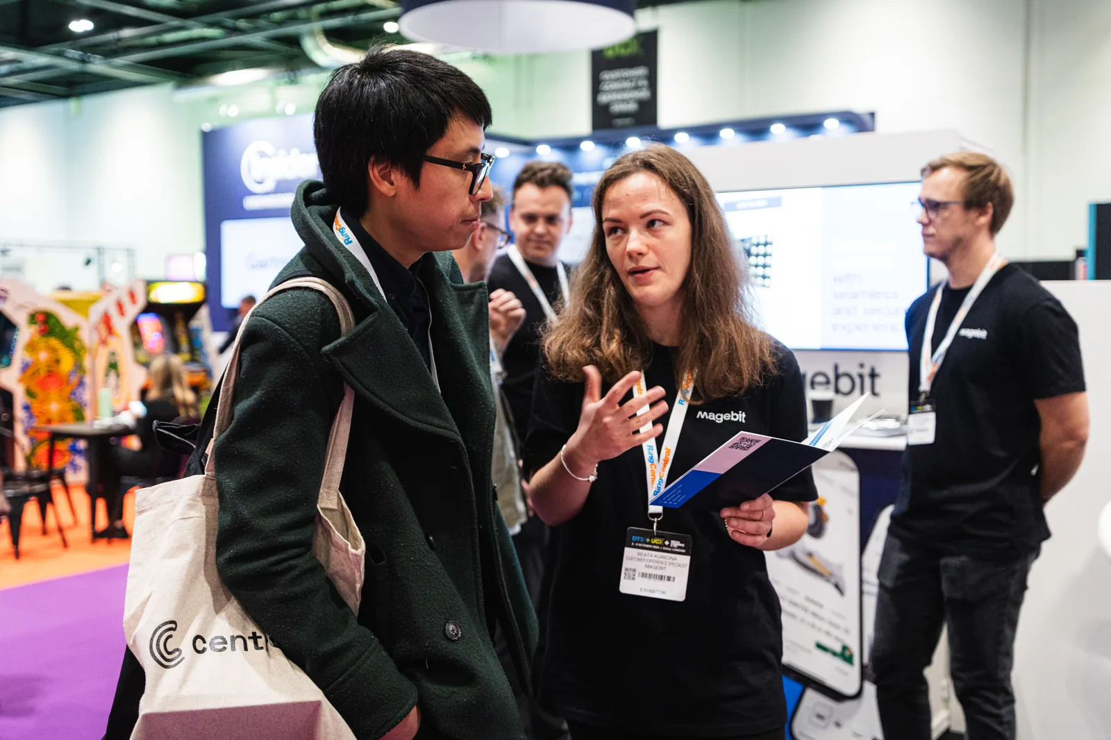 Magebit team member talking with a visitor at Digital Commerce Expo 2024
