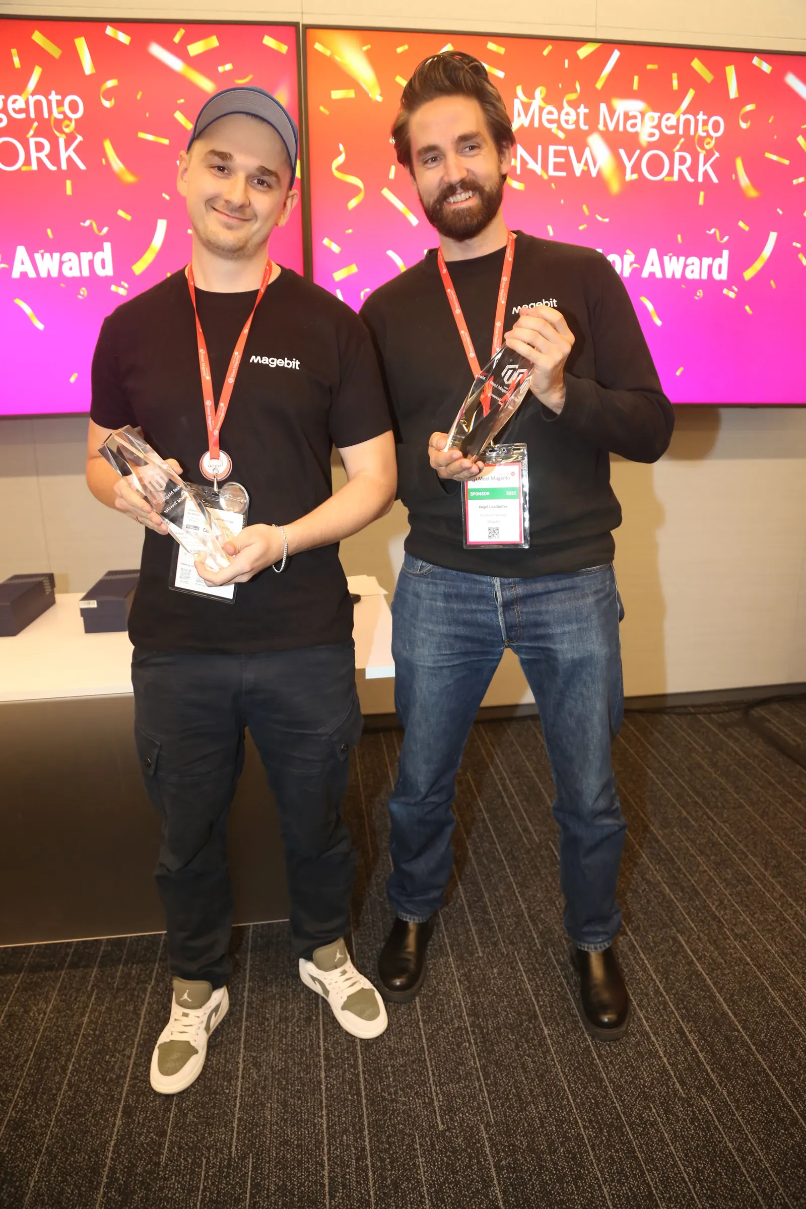 Two Magebit team members with their Meet Magento New York 2025 award trophies