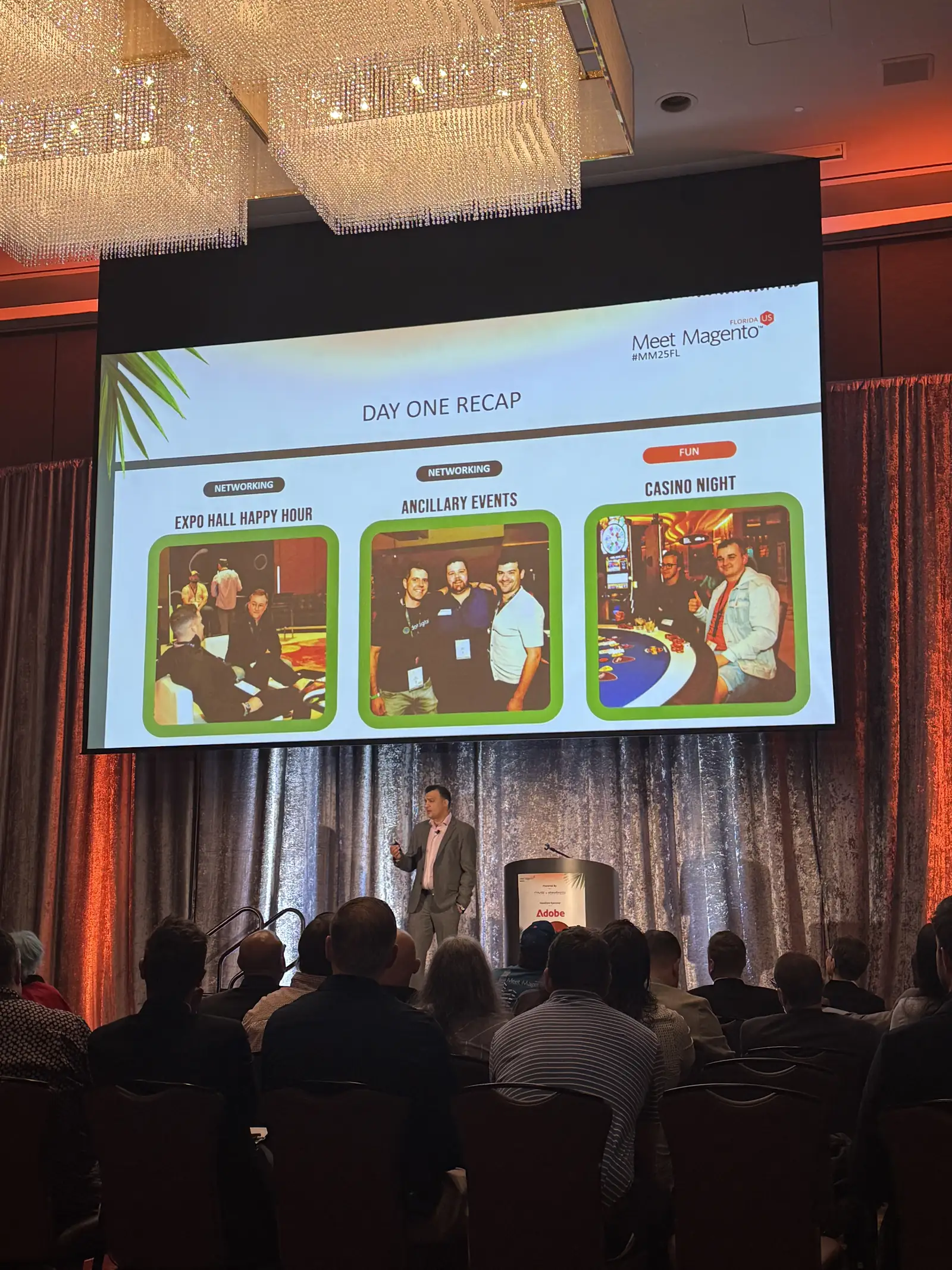Main stage at Meet Magento Florida 2025 showing the day-one recap slide to a seated audience