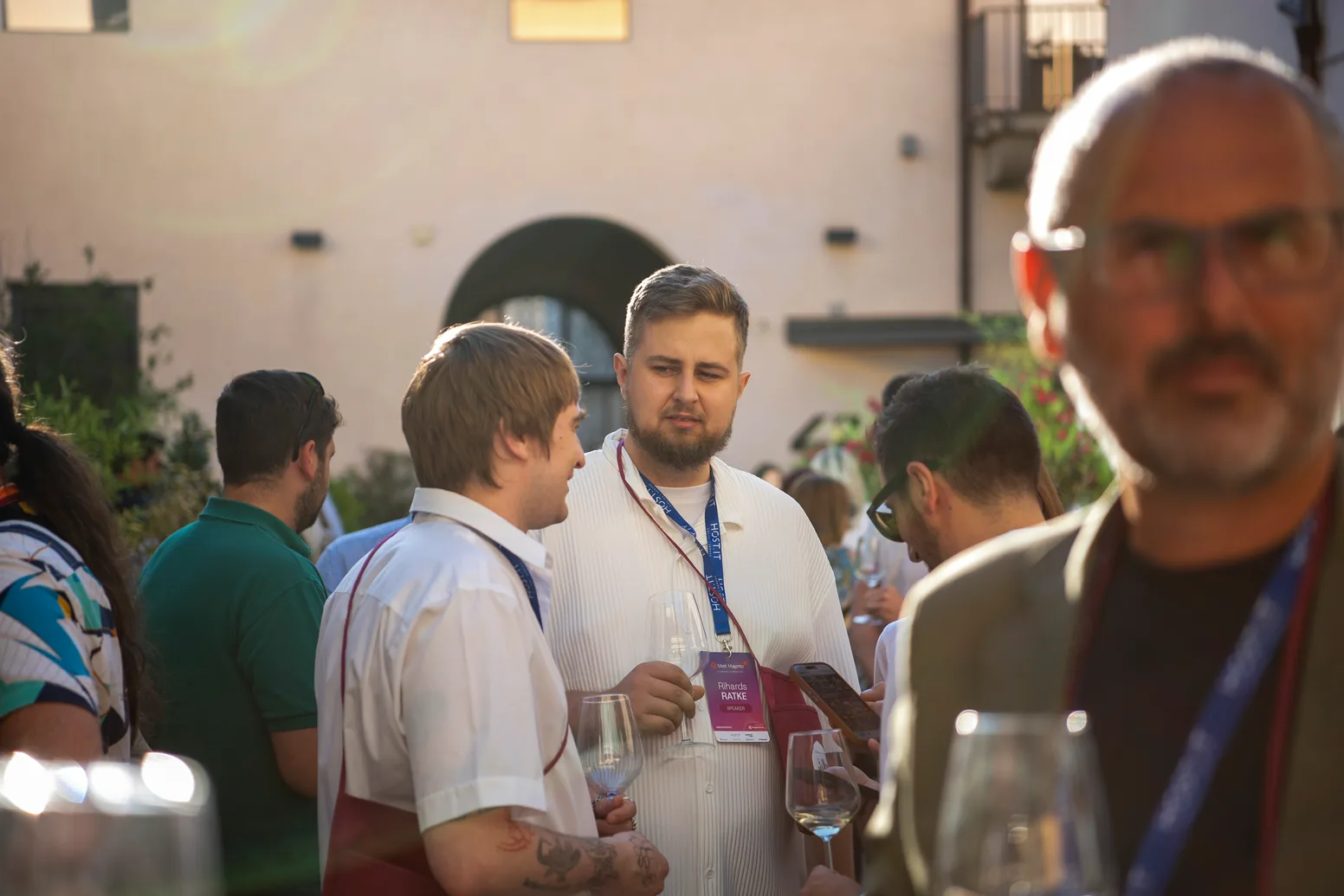 Attendees networking outdoors in the Florence sunshine at Meet Magento Italy 2026