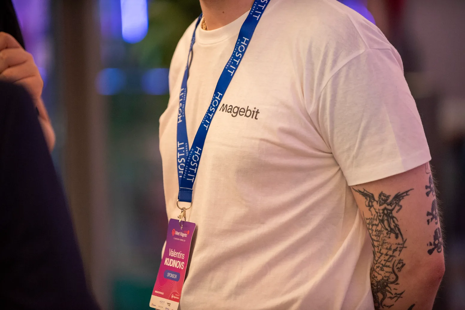 A Magebit T-shirt and Meet Magento Italy 2026 attendee badge