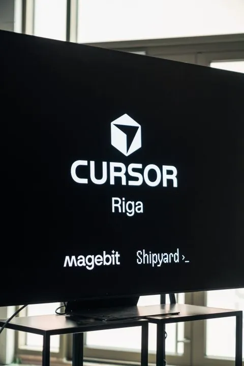 A screen at Cursor Hackathon Riga showing the Cursor, Magebit and Shipyard logos