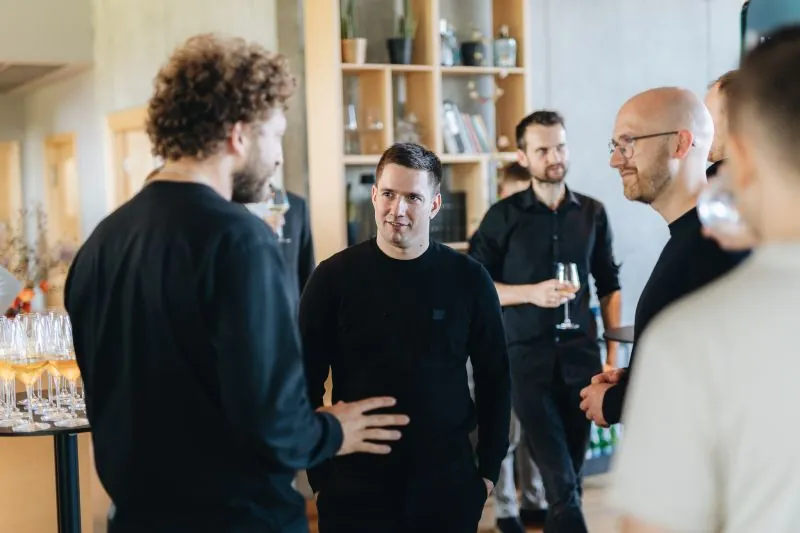 Shopify and Magebit teams talking at Shopify’s first commerce event in Latvia