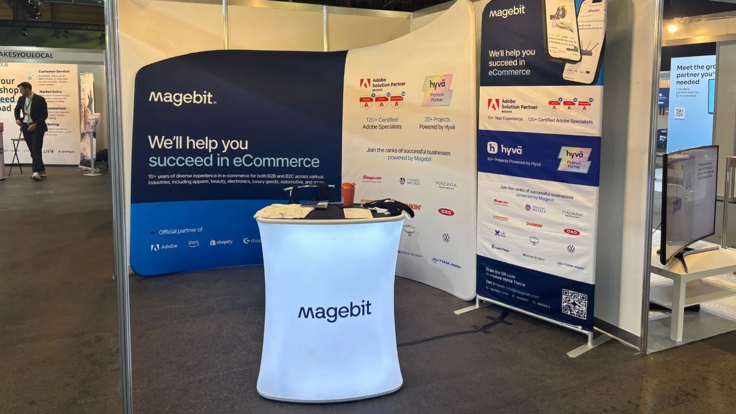 Magebit stand at Riga Comm 2026 with Adobe Solution Partner and Hyvä Platinum Partner banners