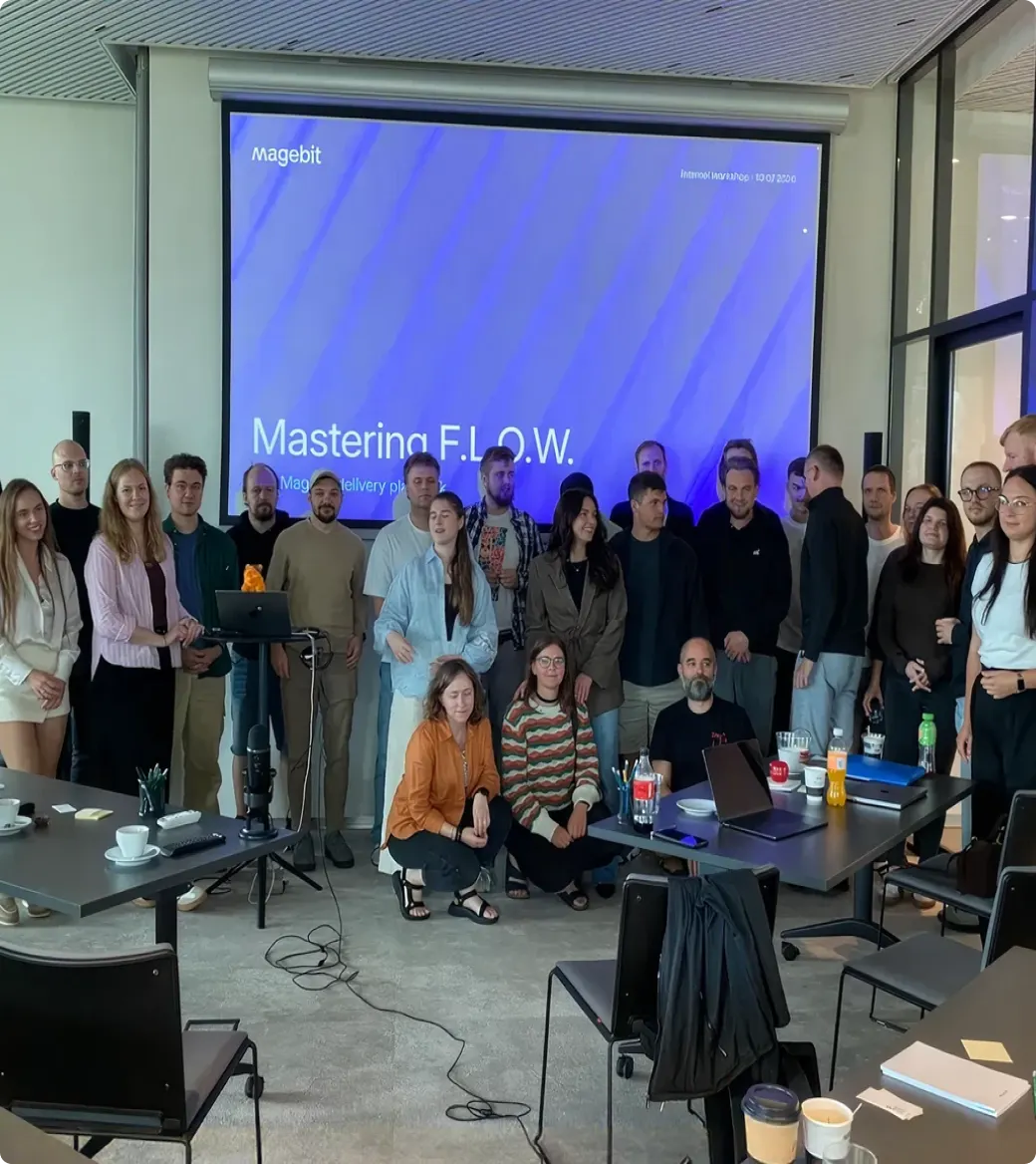 The Magebit team in front of a Mastering F.L.O.W. workshop slide.
