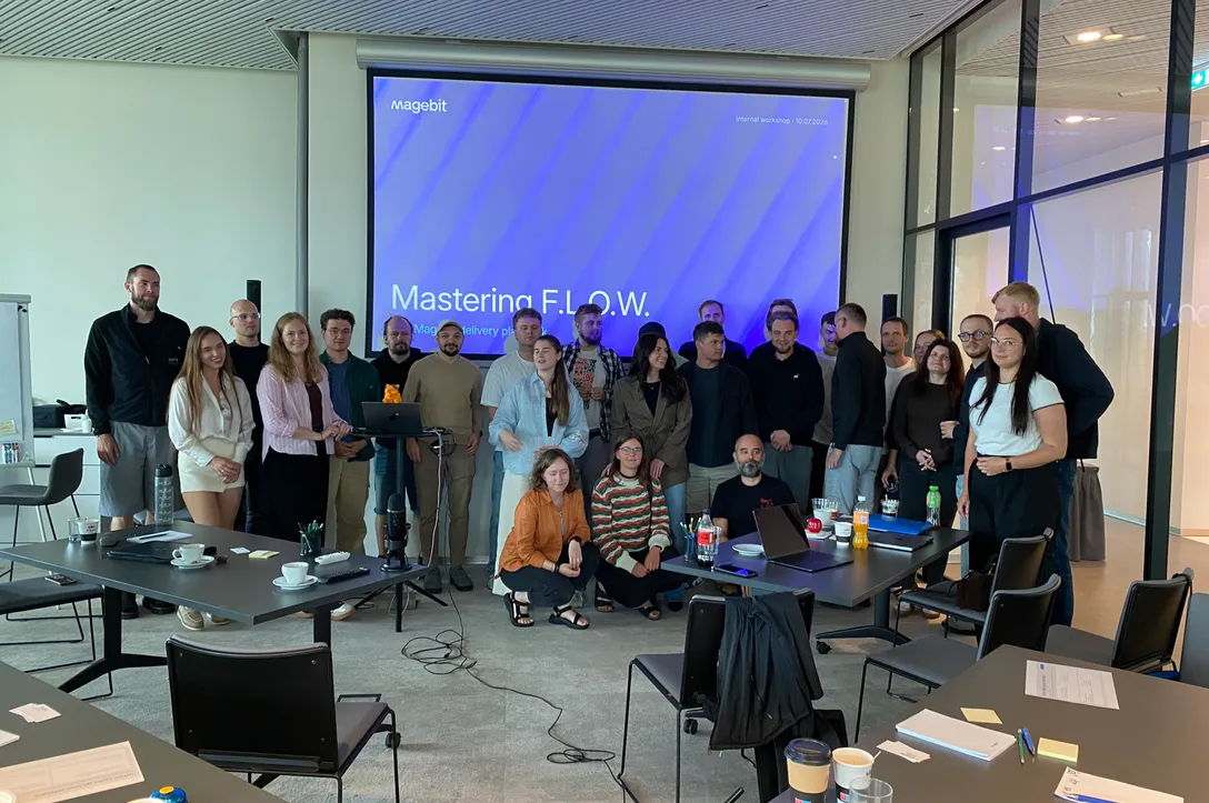 The Magebit team gathered in front of a presentation screen at an internal workshop.