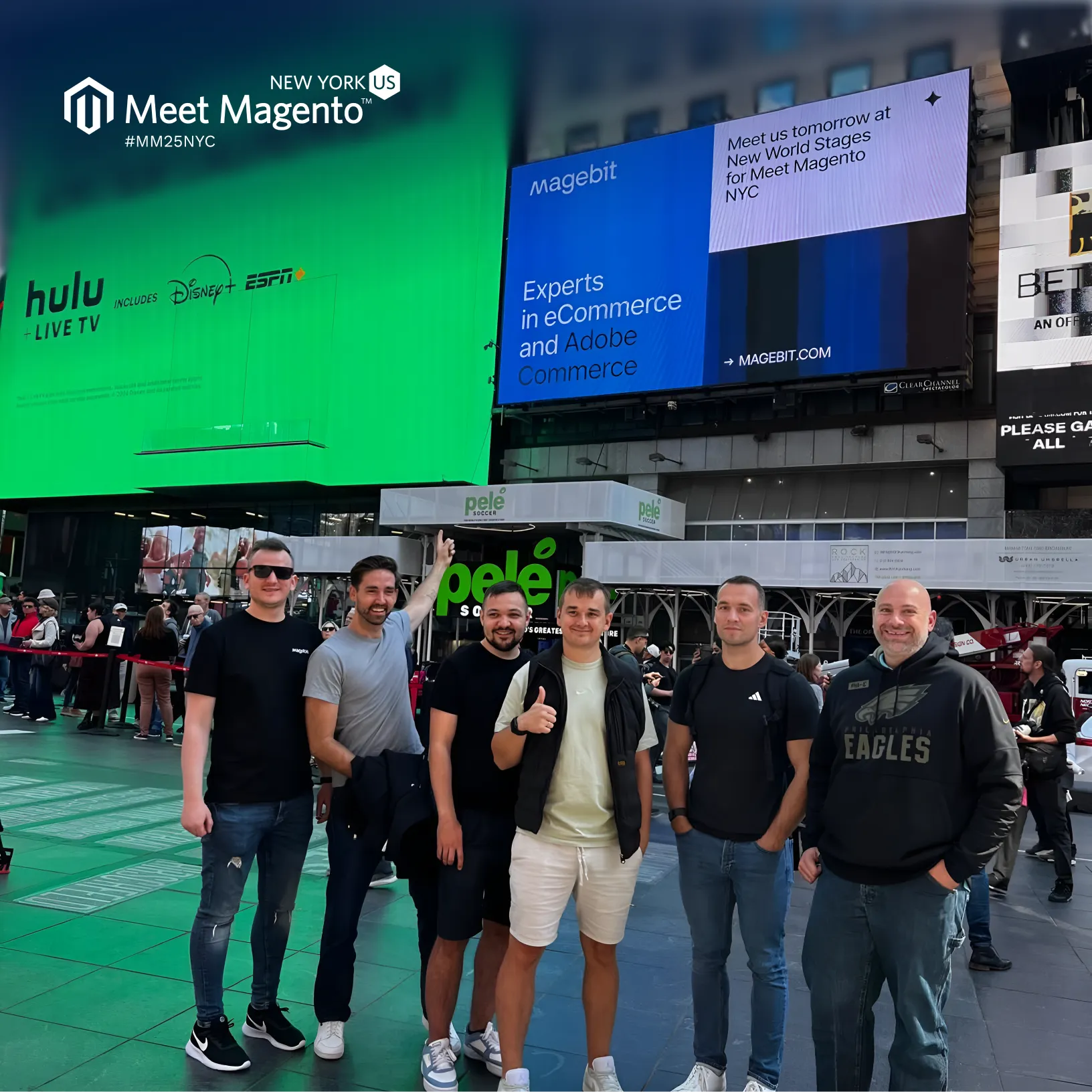 Six Magebit team members in Times Square, New York, under the Meet Magento billboards.