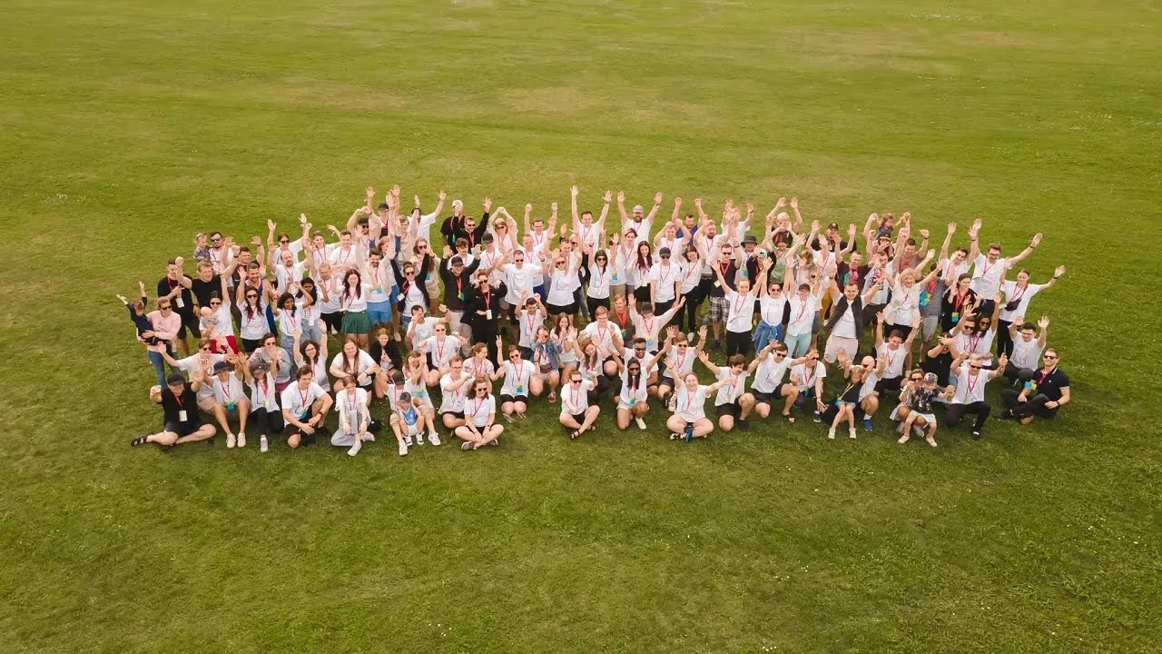 Aerial photo of the Magebit team gathered on a lawn at the 10 Year Festival weekend