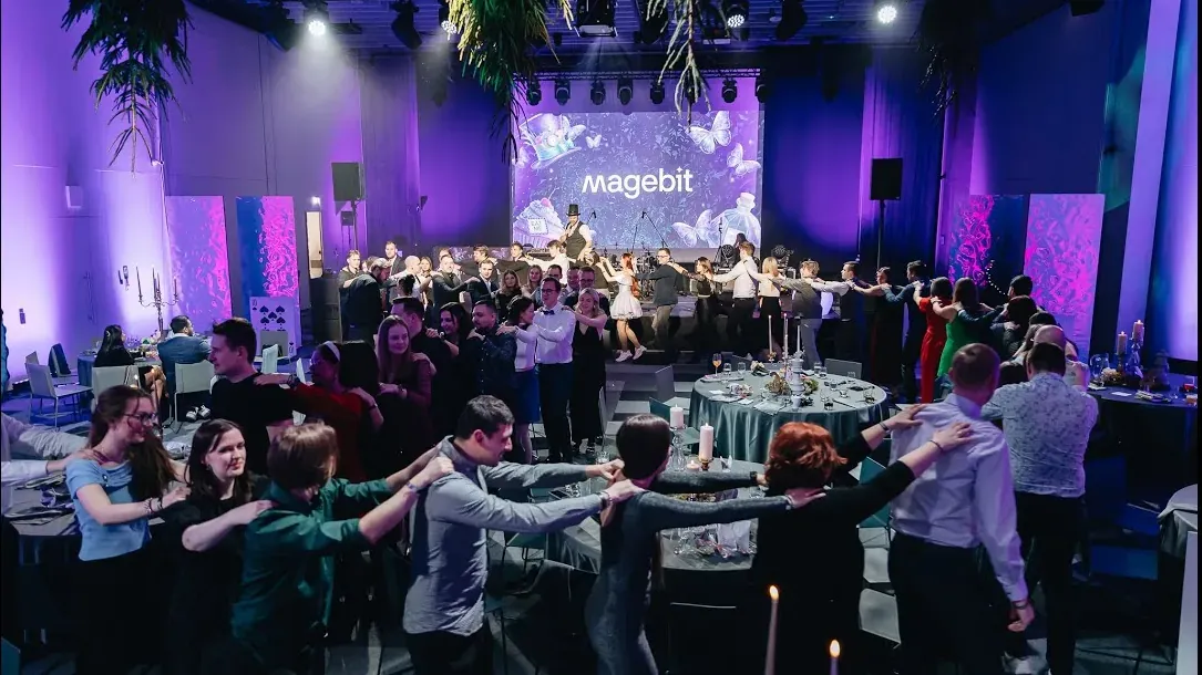 Magebit team dancing in a circle at the 2025 winter event, Winter wonderland